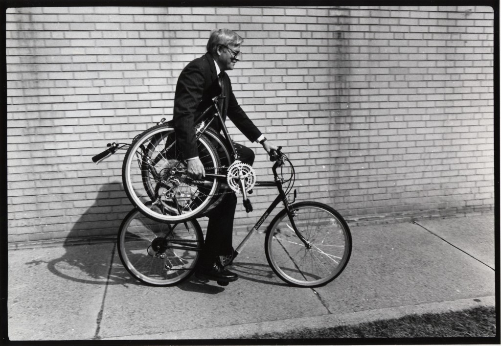 Harry-Montague-rides-and-holds-a-folded-bike