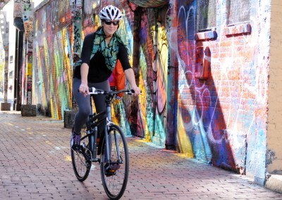 Montague Boston 8 folding bike riding with graffiti background